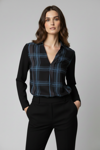 Blusa Renoir con panel frontal de gasa en negro con líneas azules y mangas de viscosa negra. La modelo la lleva con pantalón negro de vestir, mostrando el diseño elegante y ligero de la prenda | Claudia Bertolero
