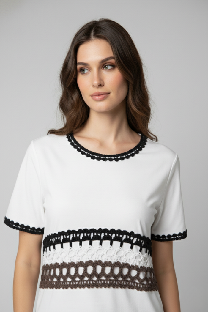 Detalle del Polo Alma Mía blanco con cuello redondo y franja de crochet en tonos negro, blanco y marrón en el torso | Claudia Bertolero